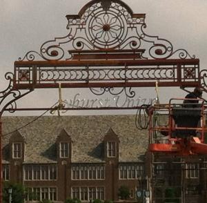 Contributed photo: The gates marking the entrance to Mercyhurst University are receiving a face lift which includes a new paint job as well as branding the landmark with the name of the college.